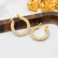 Close-up of elegant 18k gold plated stainless steel paved crystal huggie hoop earrings detail. - Rhinestone Style / Gold