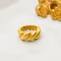 Detailed close-up of a luxurious 18k gold plated twisted stainless steel fashion ring for daily wear. - Size 6 / Twisted