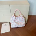 Floral seersucker shoulder bag detail showing pink string handles and cute fabric label. - Deep Pink