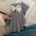 Detail shot of women's grey knitted gloves featuring elegant lace pearl bow for autumn winter. - Rhinestone Bowknot Full Finger Style / Gray