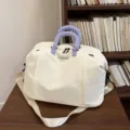 Spaziosa borsa da viaggio in tela con elegante design color-block e comodi manici imbottiti. - Bianco avorio