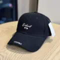 Detailed view of a black cotton baseball hat with white embroidery letters and curved brim. - Adult 54-60 Adjustable / Black