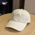 Off-white cotton baseball cap featuring 3D embroidered YY letters and curved brim style. - Adult 54-60 Adjustable / Beige