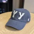 Close-up view of dark blue cotton baseball cap showcasing white 3D embroidered YY letters. - Navy Blue