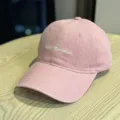 Pink washed baseball cap detailed view, showing front embroidered text and textured cotton fabric. - Adult 54-60 Adjustable / Pink