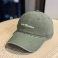 Detailed view of the washed green baseball cap featuring custom front embroidery and brim stitching. - Adult 54-60 Adjustable / Olive