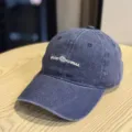 Detail view of the vintage distressed baseball cap in dark blue with embroidery logo. - Adult 54-60 Adjustable / Navy Blue