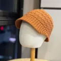 Close-up view of the stylish brown winter knitted visor hat, showcasing warm texture and cozy design. - Adult 54-60 One Size / Orange