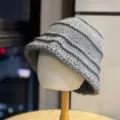 Detailed shot of a stylish grey knitted bucket hat, premium winter warmth and retro design. - Adult 54-60 Average Size / Gray