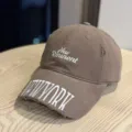 Detailed view of washed brown baseball cap, featuring distressed brim and white embroidery. - Adult 54-60 Adjustable / Coffee
