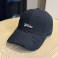 Black baseball cap detail view featuring white embroidery and distressed brim accents. - Adult 54-60 Adjustable / Black