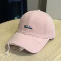 Close up view of the pink distressed baseball cap showing the delicate front embroidery detail. - Adult 54-60 Adjustable / Pink