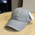 Detail view of the grey washed cotton baseball cap featuring front letter embroidery. - Adult 54-60 Adjustable / Light Gray