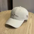 Versatile beige baseball cap with stylish embroidered text and side star motifs for casual wear. - Light Khaki