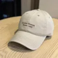 Detailed view of casual khaki baseball cap with brown embroidered letters on soft crown. - Adult 54-60 Adjustable / Khaki