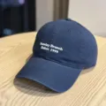 Detailed view of the navy blue cotton baseball cap featuring front white embroidery text. - Adult 54-60 Adjustable / Navy Blue