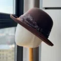 Close up detail view of the retro brown wool felt dome hat featuring a paisley ribbon band. - Adult Adjustable 54-60 / Dark Brown