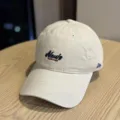 Detail view of the beige casual soft-top baseball cap with front embroidery and curved brim. - Adult 54-60 Adjustable / Beige