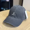 Detailed shot of dark grey washed cotton baseball cap with front letter embroidery. - Adult 54-60 Adjustable / Gray