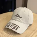 Detailed view of the vintage distressed baseball cap with stylish embroidered lettering design. - Adult 54-60 Adjustable / Beige