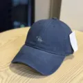 Close-up detail of the washed cotton baseball cap featuring front embroidery and tag. - Adult 54-60 Adjustable / Navy Blue