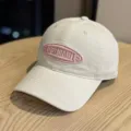 Retro washed cotton baseball cap with embroidered pink oval letter patch for casual daily sun protection. - Adult 54-60 Adjustable / Beige Pink Letter