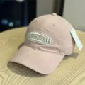 Close-up detail of the pink washed cotton baseball cap with front embroidered letter patch. - Adult 54-60 Adjustable / Pink