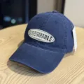 Detail view of the vintage washed navy blue baseball cap with embroidered lettering logo. - Adult 54-60 Adjustable / Navy White Letter
