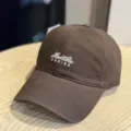 Detail view of the brown cotton baseball cap showing front letter embroidery and stitching. - Adult 54-60 Adjustable / Coffee