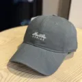 Detailed close-up of a stylish grey washed cotton baseball cap featuring front letter embroidery. - Adult 54-60 Adjustable / Gray