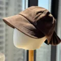 Detailed view of the brown retro suede newsboy hat showing side metal snap and pleated back. - Adult 54-60 Adjustable / Coffee