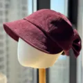 Close-up detail of the burgundy velvet newsboy hat with a cute back bow, retro style. - Adult 54-60 Adjustable / Burgundy