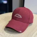 Close-up detail of a burgundy cotton baseball cap featuring white california dreaming embroidery. - Adult 54-60 Adjustable / Burgundy