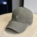 Detailed view of dark green baseball cap with minimalist white embroidered letter O. - Adult 54-60 Adjustable / Coffee