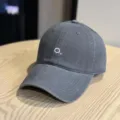 Detail view of a dark grey washed cotton baseball cap with delicate white front embroidery. - Adult 54-60 Adjustable / Gray