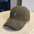 Brown corduroy baseball cap close-up view, highlighting the light blue embroidered logo. - Adult 54-60 Adjustable / Coffee