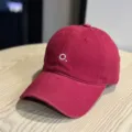 Red baseball cap with white embroidered letter, soft top and wide brim for sun protection. - Adult 54-60 Adjustable / Burgundy