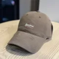 Detail view of brown washed baseball cap with white embroidery and distressed brim. - Adult 54-60 Adjustable / Coffee
