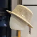 Detailed view of women's autumn winter wool bucket hat, chic fabric with metal badge. - Adult 54-60 Adjustable / Khaki