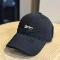 Washed black baseball cap with front letter embroidery and distressed brim, casual street style. - Adult 54-60 Adjustable / Black