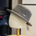 Detailed view of the winter wool felt fedora hat, showing metal tag and fine texture. - Adult 54-60 Adjustable / Coffee