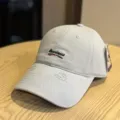 Detailed view of the washed grey baseball cap featuring vintage distressed brim and front embroidery. - Adult 54-60 Adjustable / Light Blue