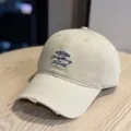 Beige baseball cap with embroidered lettering and distressed brim, casual style for daily wear. - Adult 54-60 Adjustable / Khaki