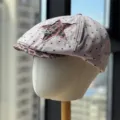 Close-up view of the polka dot newsboy cap, featuring a leopard print star patch and metal star accent. - Adult 54-60 Adjustable / Pink