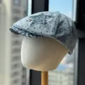 Chic denim newsboy cap featuring black polka dots, leopard star patch, and stylish metal star. - Adult 54-60 Adjustable / Light Blue