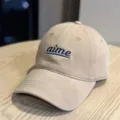 Close-up view of khaki baseball cap featuring blue embroidered lettering and wide brim design. - Adult 54-60 Adjustable / Khaki