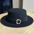 Elegant black woolen flat top hat with stylish pleated band and modern decorative buckle. - Adult Adjustable 54-60 / Black