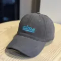 Close up detail of dark grey baseball cap featuring blue embroidered lettering and wide brim. - Adult 54-60 Adjustable / Gray