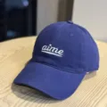 Blue cotton baseball cap with white embroidered letters, soft top and wide brim style. - Adult 54-60 Adjustable / Dark Blue