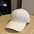 Close up view of cream white baseball cap with neat front embroidery detail for casual wear. - Adult 54-60 Adjustable / Beige